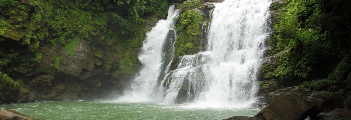 Water spills over the 60 foot Nauyaca falls outside Dominical on August 9, 2013. Horseback tours to the waterfalls include breakfast, lunch and cliff diving off the falls.