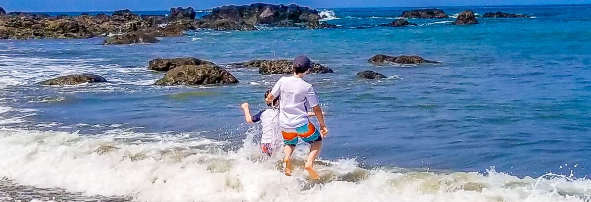 Karbin's family kids entering the ocean.