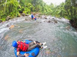 lady floating on a tube getting ready to enter the rapids blue river rincon de la vieja