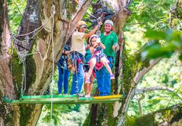 kid riding by herself from a tree platform tizati zip line rincon de la vieja