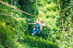 lady riding with a guide superman style tizati zip line rincon de la vieja