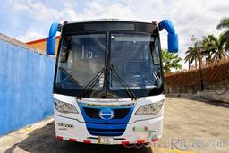 30 passenger hino senior coach front view with trees