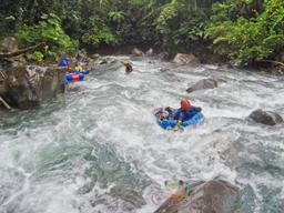 guide tubing down the currents of blue river to join the group rincon de la vieja