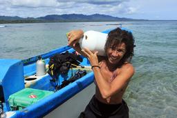 Jessica Russo, a dive master at Reef Runner Divers, unloads scuba tanks after diving in Puerto Viejo on Oct. 15, 2013.