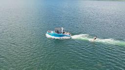 person being pulled on surf board by super air nautique g23 arenal