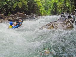 kid tubing in the rapids of the blue river rincon de la vieja