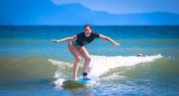 lady standing on board pollo surf school matapalo