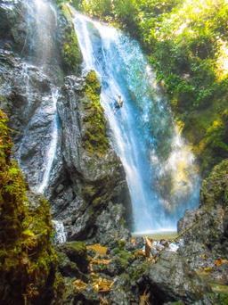 man rappelling down ventana de cielo waterfall