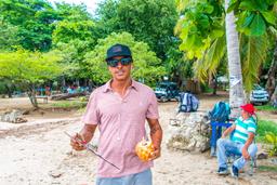 guide at the beach checking in people for the catamaran tour