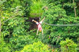 a man zip lining upside down los canones canopy tour la fortuna