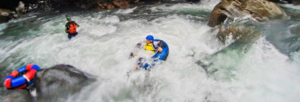 kid tubing in the rapids of blue river rincon de la vieja