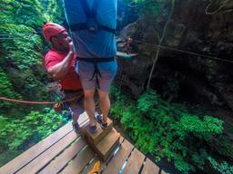 getting ready to tarzan swing white river canyon zip line rincon de la vieja